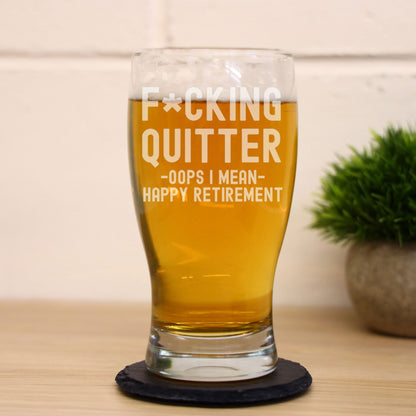 Funny engraved retirement beer glass with "F*cking Quitter, Oops I mean Happy Retirement" design. Optional slate coaster. Great novelty gift for retirees.