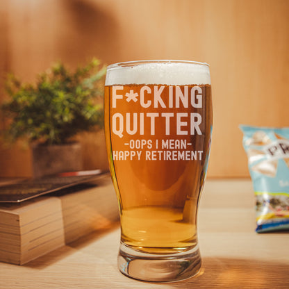 Funny engraved retirement beer glass with "F*cking Quitter, Oops I mean Happy Retirement" design. Optional slate coaster. Great novelty gift for retirees.